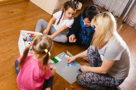 Mom and kids playing with erector sets