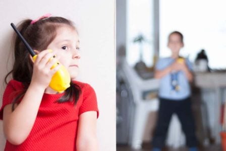 Siblings playing together with walkie talkies