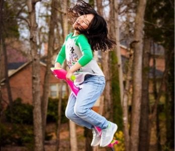 Young girl riding a pogo stick