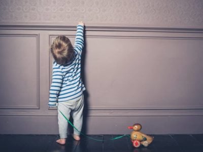 Toddler pulling a toy duck