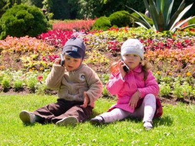 Toddlers chatting on toy phones next to each other