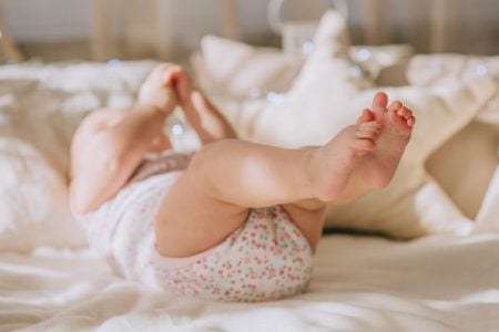 baby laying down with feet up