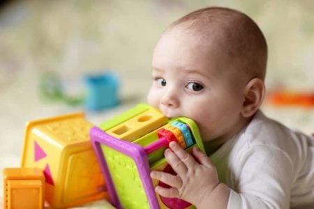 Baby biting a toy