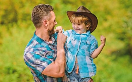 A father playing with his son in the park.