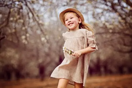 Cheerful little girl playing in the park