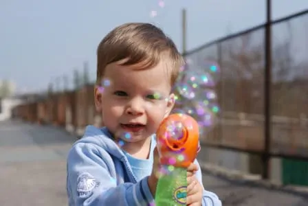 Small boy playing with bubble toy