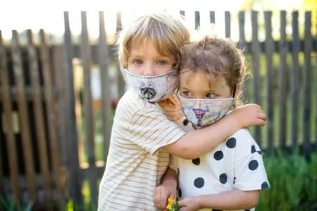 Cute siblings wearing face masks