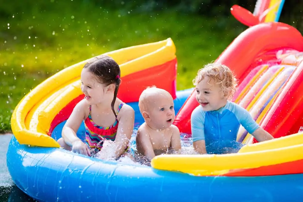 Kids playing in an inflatable water slide