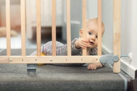 Baby playing near the baby gate