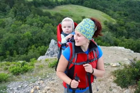 Mom carrying baby in a hiking carrier