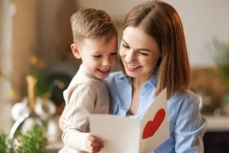 Mother and son reading birthday greeting card