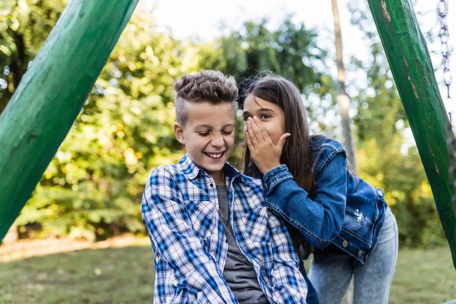 Two happy kids laughing and having fun in the park