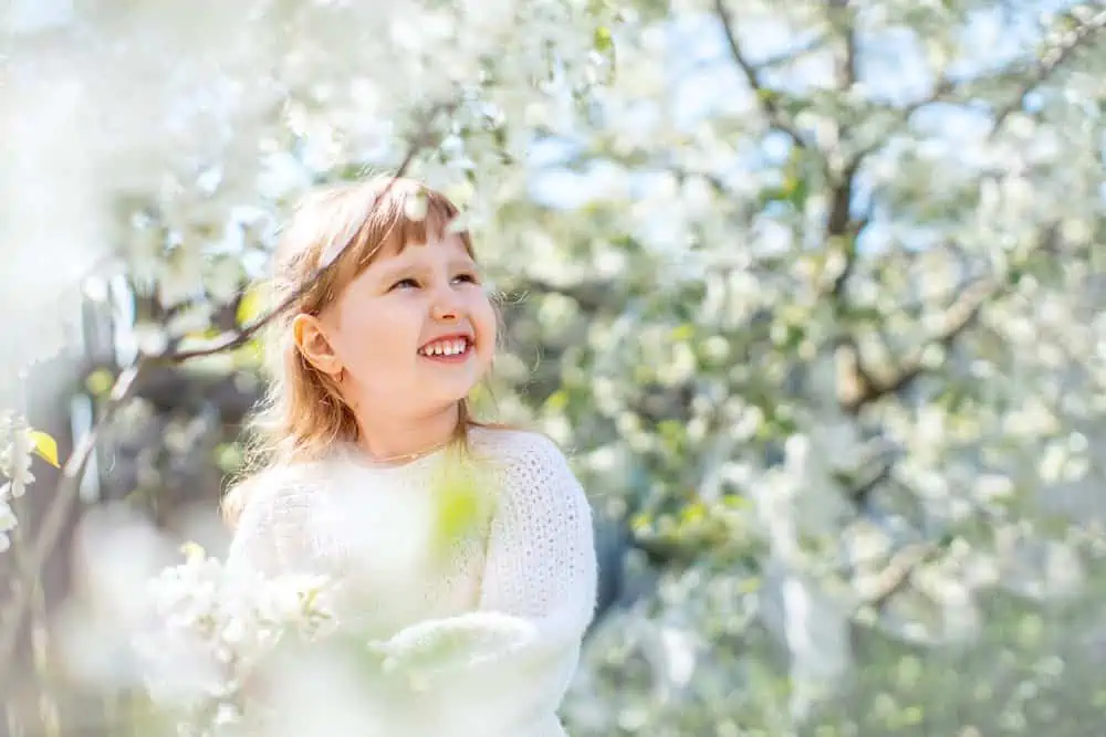 Little girl enjoying sun rays in the park