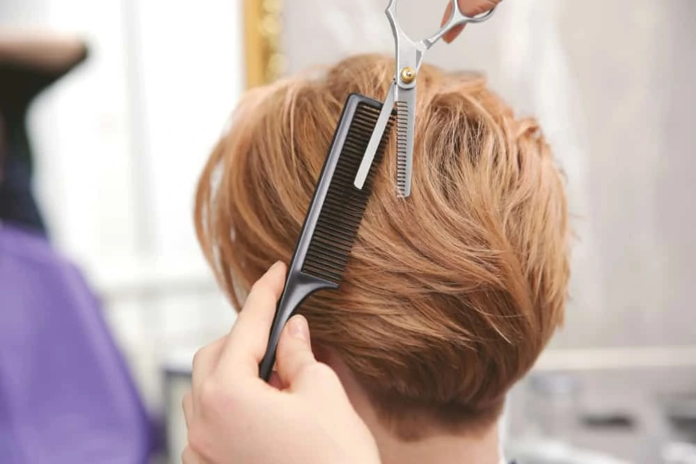 Woman with hair loss getting a hair cut