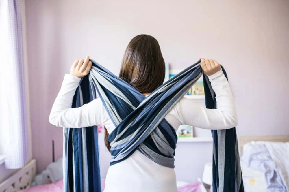 Woman using a woven baby wrap